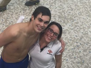 Senior David Rahner celebrates his win in the 100 back with his favorite coach Colleen Parsons.